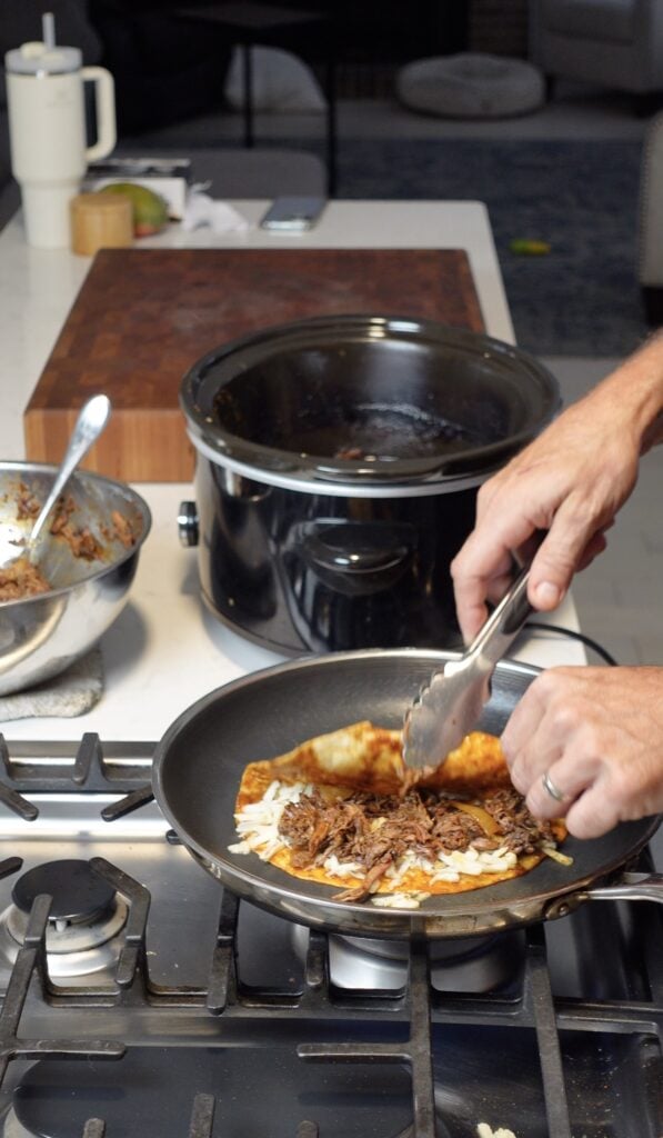 A taco cooking in a skillet.